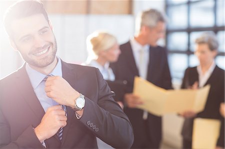 Businessman smiling at the camera at the office Stock Photo - Premium Royalty-Free, Code: 6109-08488724