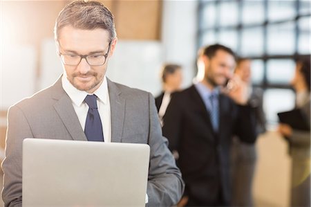 simsearch:6109-08488759,k - Businessman using his laptop at the office Stock Photo - Premium Royalty-Free, Code: 6109-08488737