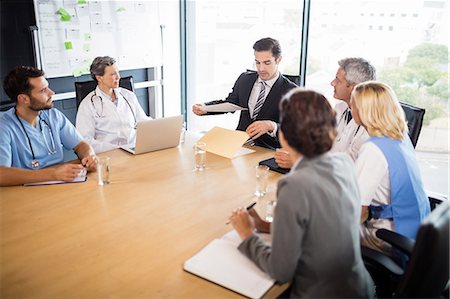 simsearch:6109-08488900,k - Business team having a meeting at the office Stock Photo - Premium Royalty-Free, Code: 6109-08488863