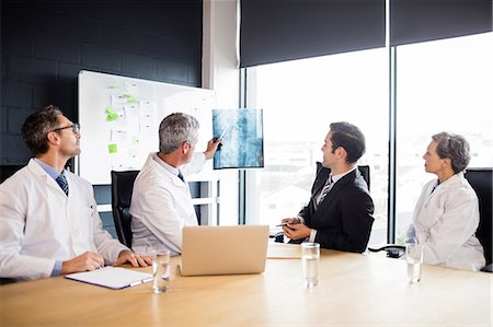 simsearch:6109-08488900,k - Medical team having a meeting at the office Stock Photo - Premium Royalty-Free, Code: 6109-08488870