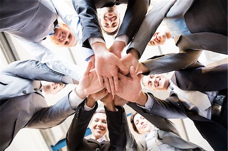 simsearch:6109-08394968,k - Business team standing in circle at the office Stock Photo - Premium Royalty-Free, Code: 6109-08488816