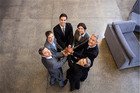simsearch:6109-08488781,k - Business team putting their hands together at the office Stock Photo - Premium Royalty-Free, Code: 6109-08488818