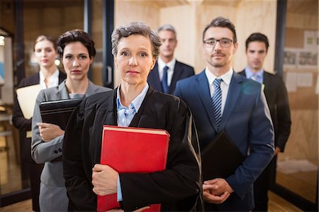simsearch:400-07057747,k - Legal team looking at the camera at the office Stock Photo - Premium Royalty-Free, Code: 6109-08488827