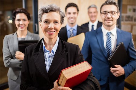 simsearch:6109-08488776,k - Business team looking at the camera at the office Stock Photo - Premium Royalty-Free, Code: 6109-08488825