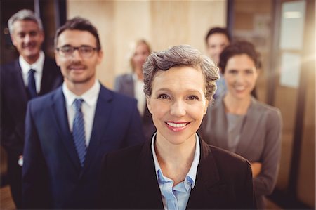 simsearch:6109-08488781,k - Business team smiling at the camera at the office Stock Photo - Premium Royalty-Free, Code: 6109-08488831