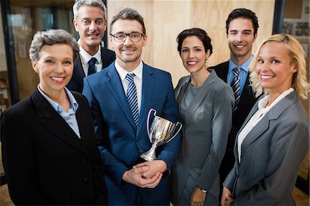 simsearch:6109-08394968,k - Succesful business team with an award at the office Stock Photo - Premium Royalty-Free, Code: 6109-08488834