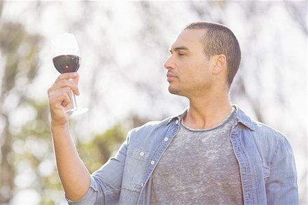 simsearch:614-06973691,k - Serious man looking at a glass of red wine in garden Stock Photo - Premium Royalty-Free, Code: 6109-08488964