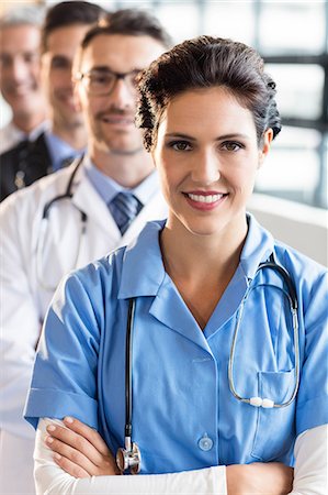 simsearch:6109-08488902,k - Medical team smiling at camera together at the hospital Stock Photo - Premium Royalty-Free, Code: 6109-08488920