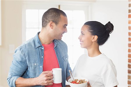 simsearch:6109-08390074,k - Smiling couple eating breakfast together in the kitchen at home Foto de stock - Sin royalties Premium, Código: 6109-08489001