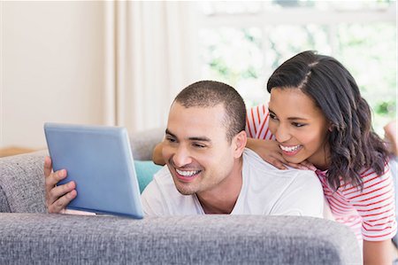 simsearch:6109-07497359,k - Happy couple using tablet lying on the couch at home Fotografie stock - Premium Royalty-Free, Codice: 6109-08489112