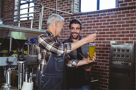 simsearch:6109-08489288,k - Team of brewers working together at the local brewery Stock Photo - Premium Royalty-Free, Code: 6109-08489385