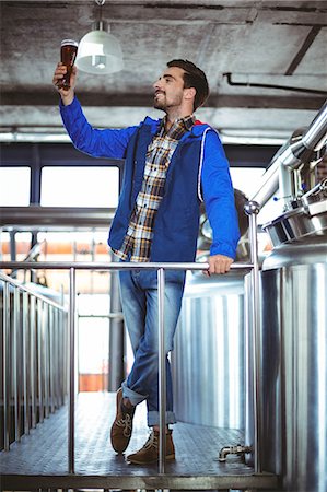 product photography alcohol - Happy brewer checking pint of beer at the local brewery Stock Photo - Premium Royalty-Free, Code: 6109-08489442