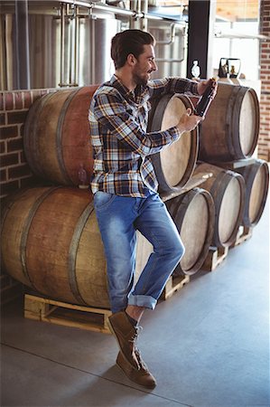 product photography alcohol - Happy brewer with his produce at the local brewery Stock Photo - Premium Royalty-Free, Code: 6109-08489448