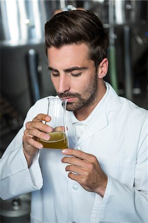 simsearch:6109-08489440,k - Focused brewer testing his beer in the brewery factory Stock Photo - Premium Royalty-Free, Code: 6109-08489572