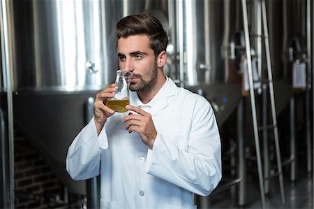 simsearch:6109-08489635,k - Focused brewer testing his beer at the microbrewery Stock Photo - Premium Royalty-Free, Code: 6109-08489574