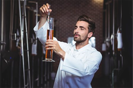 simsearch:6109-08489635,k - Focused brewer testing his beer in the brewery factory Stock Photo - Premium Royalty-Free, Code: 6109-08489580