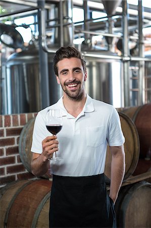 simsearch:6109-08489454,k - Smiling vintner with red wine at the Stock Photo - Premium Royalty-Free, Code: 6109-08489518