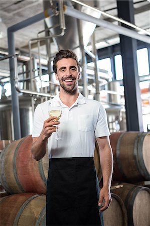 simsearch:6109-08489635,k - Handsome man holding a glass of wine in a brewery Stock Photo - Premium Royalty-Free, Code: 6109-08489522