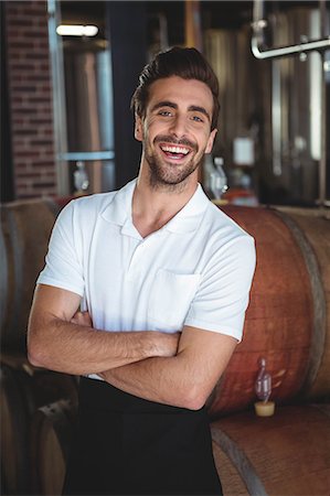 simsearch:6109-08489527,k - Handsome brewer crossing his arms in a brewery Foto de stock - Sin royalties Premium, Código: 6109-08489527