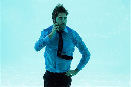 simsearch:6109-08489756,k - Businessman on the phone underwater in swimming pool Stock Photo - Premium Royalty-Free, Code: 6109-08489777