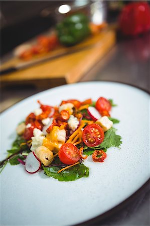 simsearch:6109-08489861,k - Cherry tomato salad on counter in commerical kitchen Stock Photo - Premium Royalty-Free, Code: 6109-08489924