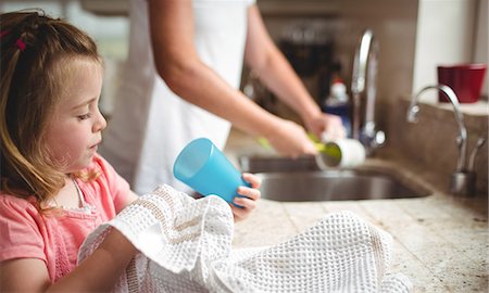 family cleaning - Daughter helping her mom washing the dishes at home Stock Photo - Premium Royalty-Free, Code: 6109-08434656