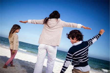 simsearch:6109-07496983,k - Cute family with arms outstretched on the beach Stock Photo - Premium Royalty-Free, Code: 6109-08434775