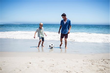 father and son playing football at beach - Father and son playing soccer on the beach Stock Photo - Premium Royalty-Free, Code: 6109-08434780