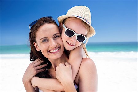 piggyback daughter at beach - Mother giving piggy back to her daughter on the beach Stock Photo - Premium Royalty-Free, Code: 6109-08434788