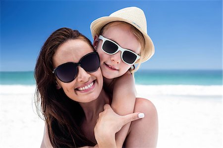 piggyback daughter at beach - Mother giving piggy back to her daughter on the beach Stock Photo - Premium Royalty-Free, Code: 6109-08434789
