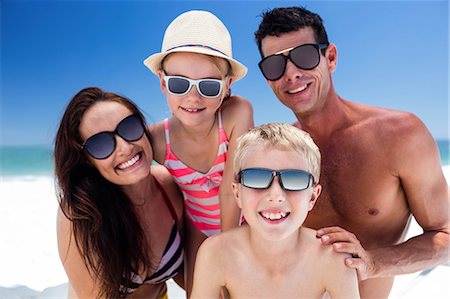 simsearch:6109-06003627,k - Cute family wearing sunglasses on the beach Stock Photo - Premium Royalty-Free, Code: 6109-08434790