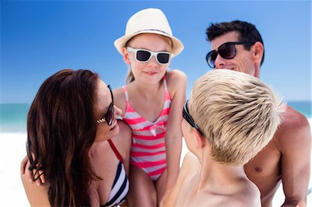 simsearch:6109-08434823,k - Cute family wearing sunglasses on the beach Stock Photo - Premium Royalty-Free, Code: 6109-08434791