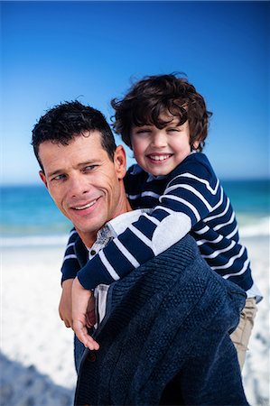 simsearch:6109-08434724,k - Father giving piggy back to his son on the beach Photographie de stock - Premium Libres de Droits, Code: 6109-08434849