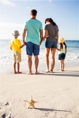 sea starfish pictures - Cute family standing in the sand on the beach Photographie de stock - Premium Libres de Droits, Code: 6109-08434869