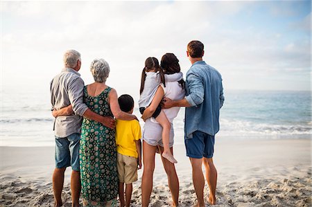 simsearch:6109-08434823,k - Cute family facing the sea on the beach Stock Photo - Premium Royalty-Free, Code: 6109-08434883