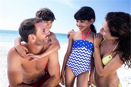 ethnic moms and daughters beach - Cute family having a funny discussion on the beach Stock Photo - Premium Royalty-Free, Code: 6109-08434814