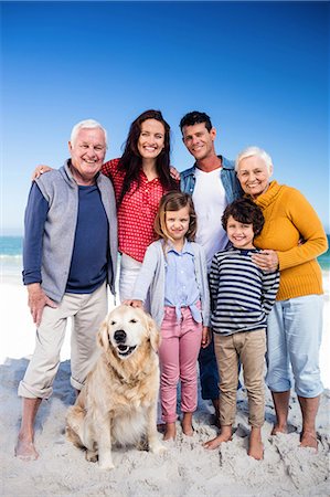 family dog grandparents parents child - Cute family standing with their dog on the beach Stock Photo - Premium Royalty-Free, Code: 6109-08434906