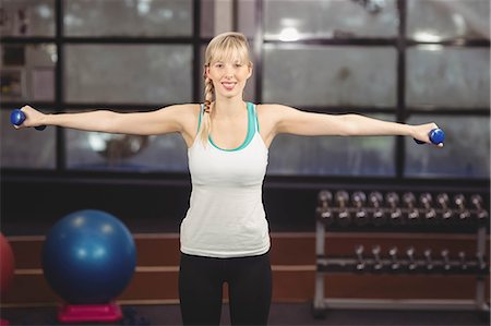 simsearch:6109-08435609,k - Blonde woman exercising with dumbbells at the leisure center Stockbilder - Premium RF Lizenzfrei, Bildnummer: 6109-08435027