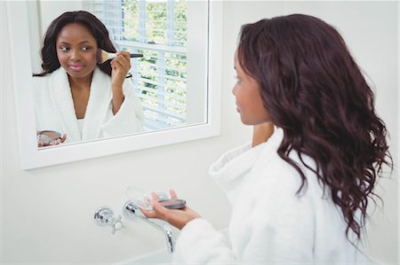 simsearch:6109-08435535,k - Beautiful woman applying make up in the bathroom Stock Photo - Premium Royalty-Free, Code: 6109-08435190