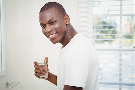 Handsome man drinking water in the bathroom Stock Photo - Premium Royalty-Free, Code: 6109-08435200