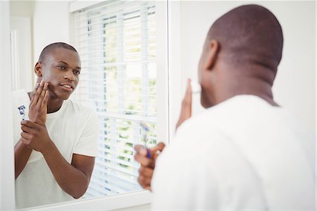 Handsome man about to shave in the bathroom Stock Photo - Premium Royalty-Free, Code: 6109-08435209