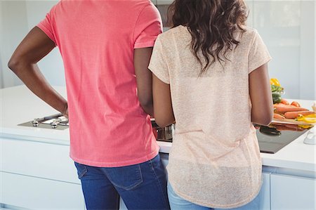 simsearch:6109-08435318,k - Ethnic couple cooking in the kitchen Stock Photo - Premium Royalty-Free, Code: 6109-08435388