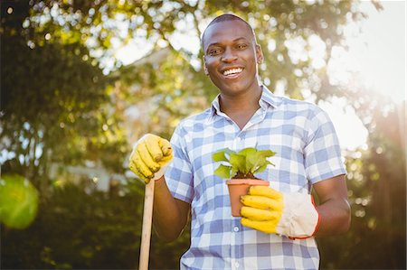 simsearch:6109-08435446,k - Handsome man doing some gardening outside Stock Photo - Premium Royalty-Free, Code: 6109-08435447