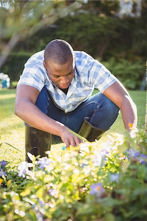 simsearch:6109-08435446,k - Handsome man doing some gardening outside Stock Photo - Premium Royalty-Free, Code: 6109-08435448