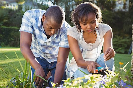 simsearch:6109-08435324,k - Ethnic couple doing some gardening outside Stock Photo - Premium Royalty-Free, Code: 6109-08435453