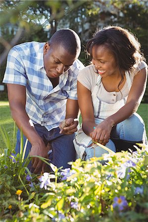 simsearch:6109-08435324,k - Ethnic couple doing some gardening outside Stock Photo - Premium Royalty-Free, Code: 6109-08435454