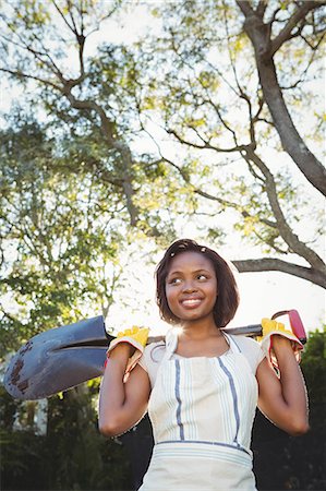 simsearch:6109-08435446,k - Pretty woman holding a shovel in the garden Stock Photo - Premium Royalty-Free, Code: 6109-08435459