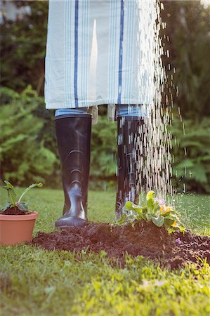 simsearch:6109-08435446,k - Woman watering plants in the garden Stock Photo - Premium Royalty-Free, Code: 6109-08435464
