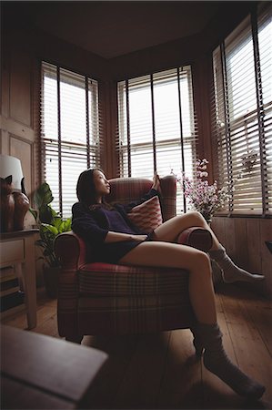 Brunette relaxing on the sofa at home Stock Photo - Premium Royalty-Free, Code: 6109-08435658