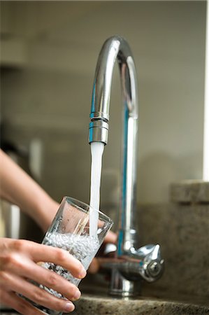 fill glass with water - Pretty blonde woman filling a glass of water at home Stock Photo - Premium Royalty-Free, Code: 6109-08435699